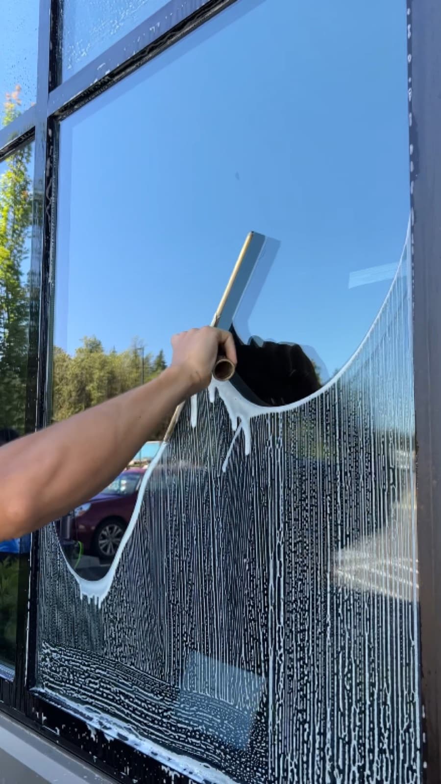 Window cleaning with a squeegee on glass